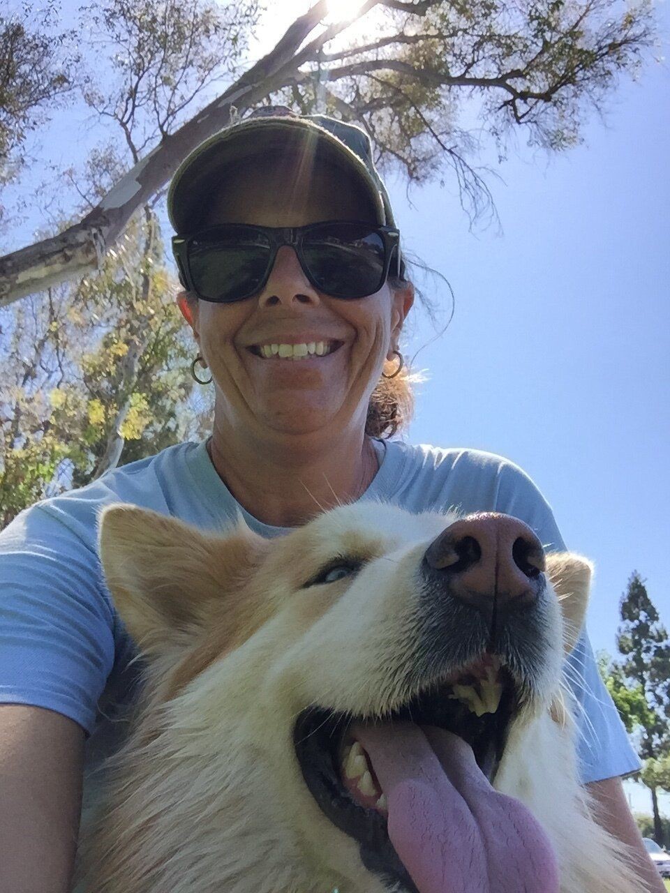 Diane Smith, founder and master trainer - wearing sunglasses and baseball cap. Her dog's nose is the lower frame.